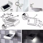 Montage mural d’une lampe solaire en aluminium avec schéma, visserie, interrupteur et vue allumée/extérieure.